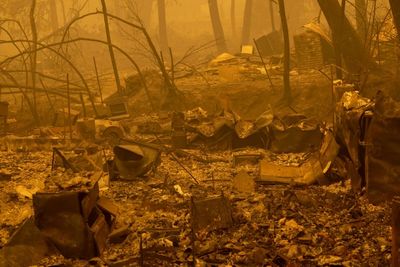 Year's largest fire burns through dry terrain to destroy California homes
