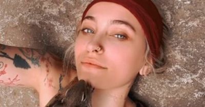 Paris Jackson lets a squirrel crawl over her chest and face on camping trip