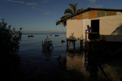 Fiji, moving villages inundated by rising seas, wants big emitters to pay