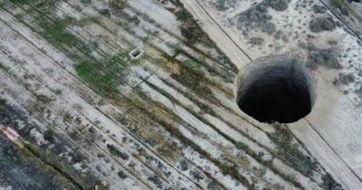 Huge sinkhole tears ground open as authorities probe what lurks underneath