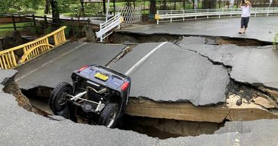 Car swallowed by sinkhole during raging floods leading to evacuation of 500,000