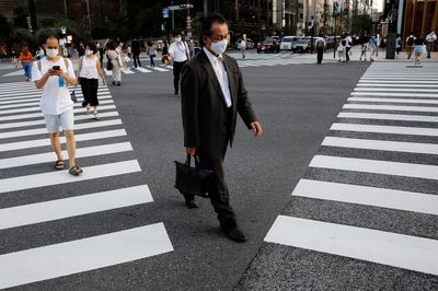 Work stoppages and no chatting at lunch: Japan Inc grapples with COVID