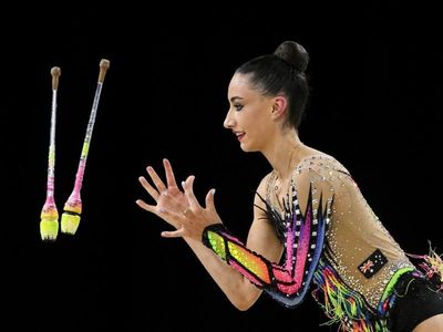 Gymnast hopes tearful gold will mean funds