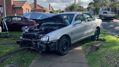 Man dies in police custody after crashing car through fence in Melbourne's north