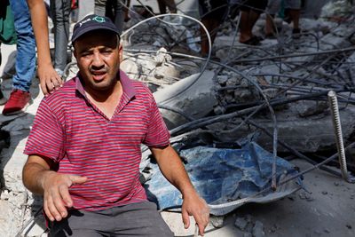 Palestinians sift through rubble at Gaza camp hit in Israeli strike