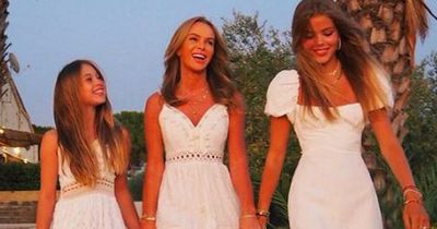 Amanda Holden matches lookalike daughters in all white as they enjoy a trip to Sicily