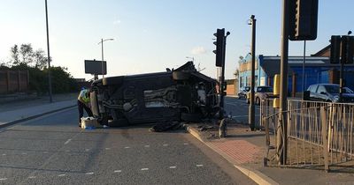 Suspected drunk driver flips Bentley crashing into traffic lights