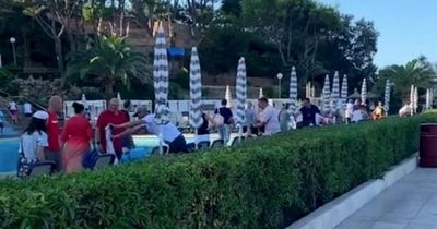 Frenzied holidaymakers sprint through hotel bar to bag poolside sunbeds