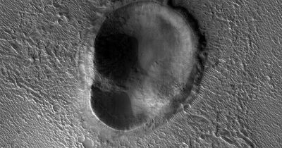 New images from Nasa space probe show giant 'ear-shaped crater' on Mars