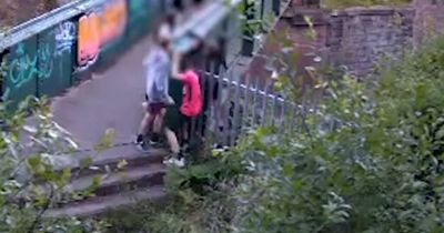 Heart-stopping pictures show children dangling from bridge over railway