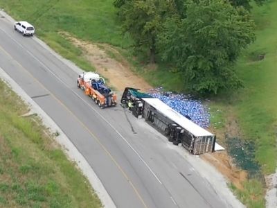 Semi-truck full of Bud Light overturns on Kentucky highway spilling cans everywhere