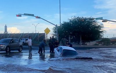 Watch: Woman rescued after vehicle plunges into sinkhole