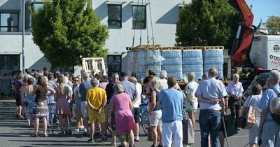 Hundreds of households wake up without water in heatwave as locals flock to water stations