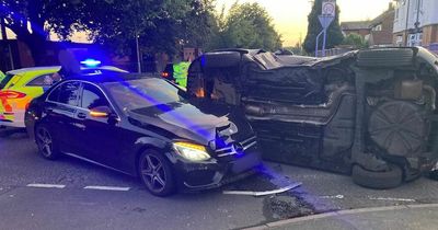 Car overturns in dramatic smash before cops stop TWO drivers filming scene on their phones