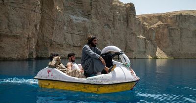 Taliban shown smiling with guns on pedalos as they celebrate Afghan takeover anniversary