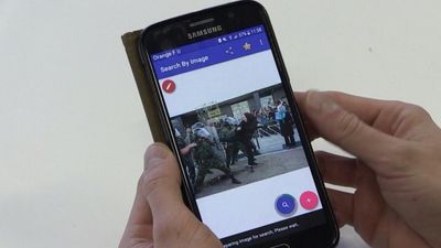 How can I use my smartphone to verify photos and fight misinformation?