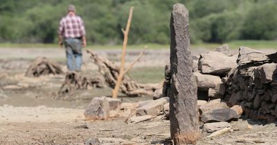 Hidden underwater village resurfaces for first time in 40 years as UK heatwave dries lake