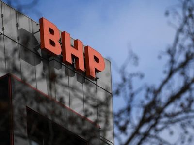 BHP surges on record FY, coy on OZ Min bid