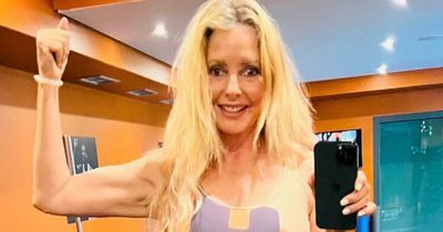 Carol Vorderman shows off abs and tiny waist as she insists she 'isn't giving up' at 61