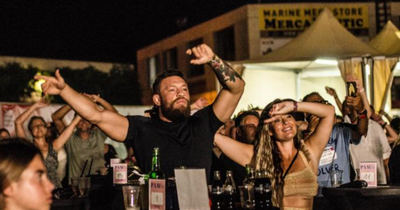 Conor McGregor and partner Dee Devlin enjoy concert with hundreds of revellers in Majorca