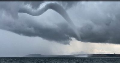 Giant waterspout emerges from sea as UK is hit with thunderstorms and flooding