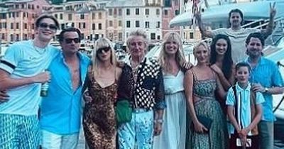 Rod Stewart poses with his eight children as wife Penny says her heart is 'bursting'
