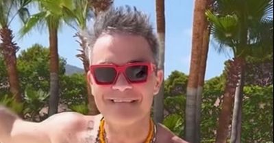 Robbie Williams dances shirtless as he enjoys lavish Ibiza break with wife Ayda Field