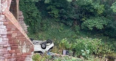 Car plunges off Scots bridge before landing on roof in East Lothian river