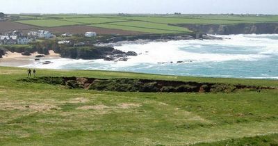 Woman dies after falling into 80ft hole while on clifftop walk with partner