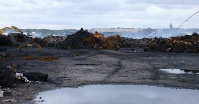 Impact of 'enormous' blaze on family-run fishery will be a 'tragedy' as fire service drains 2.5m gallons from lake