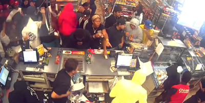 Flash mob turns scary as more than a dozen people are seen ransacking a 7-11 in wild attack caught on camera