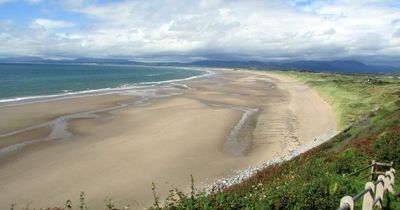 The beautiful sandy North Wales beach overlooked by a castle