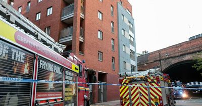 Crews tape off Manchester city centre street after blaze in high rise building