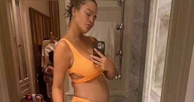 Pregnant Chrissy Teigen showcases her blossoming baby bump in family holiday photos