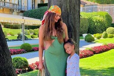 Pregnant Chrissy Teigen displays her growing baby bump on holiday