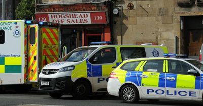 Cops descend outside Paisley off-licence after alleged rammy in street