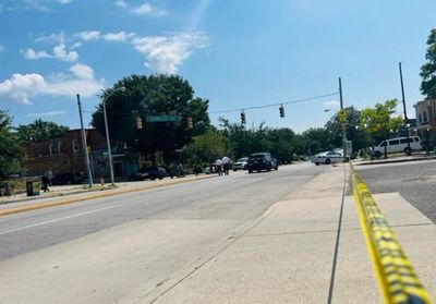 One dead and six injured after two gunmen jump out of car and ambush group of people in Baltimore street