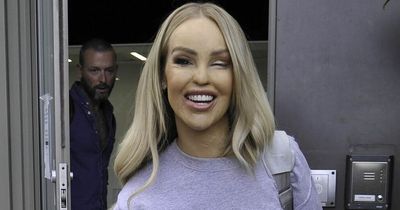 Katie Piper gives a smile as she's seen for the first time since emergency eye surgery