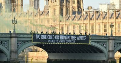 Energy bills activists set off flares and protest near Westminster after price cap news