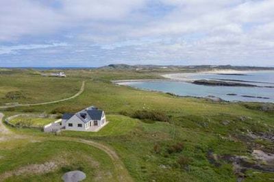 Remote Scottish island home listed for sale with two wind turbines that earn their owners £150,000 a year