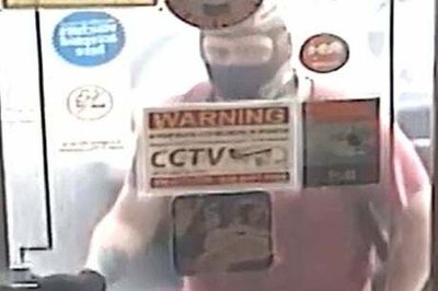 Appeal after robber armed with meat cleaver storms east London shop