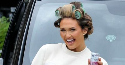 Charlotte Dawson arrives at Manchester Airport with can of gin and hair in rollers as she jets off to Rome with her fiance