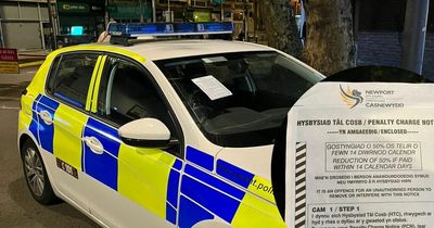 Fixed penalty notice placed on police car parked on double yellow lines in city centre