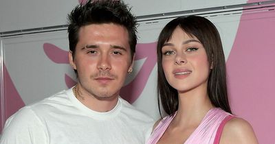 Brooklyn Beckham and wife Nicola Peltz match in pink outfits as they pack on the PDA