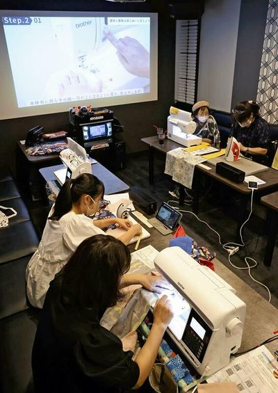 Sounds of sewing ring out in class at Nagoya karaoke shop