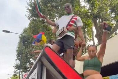 Shocking moment Notting Hill Carnival revellers destroy bus stop after dancing on top
