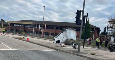 Driver escapes with minor injuries after van flips onto roof in crash with BMW