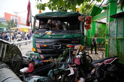 Truck in Indonesia crashes at school bus stop, killing 10