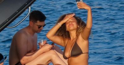 Stunning Amber Gill necks drinks in tiny bikini on boozy Mykonos boat trip