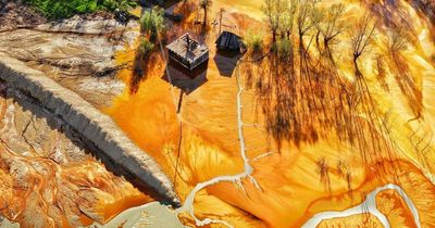 Abandoned Romanian village drowned beneath toxic lake of fluorescent yellow sludge